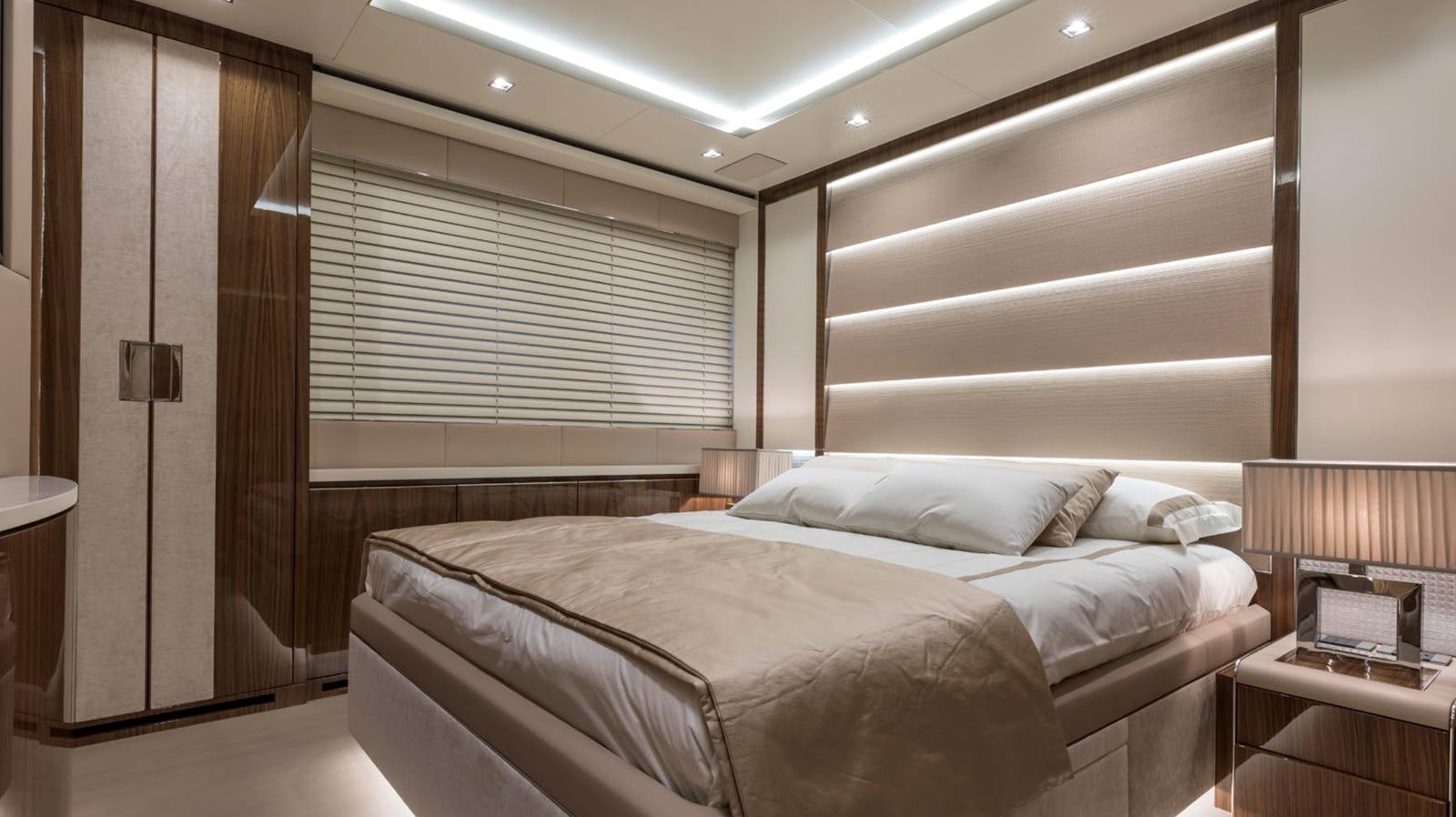 a room with a bed and a window aboard GOLDENEYE Yacht for Sale
