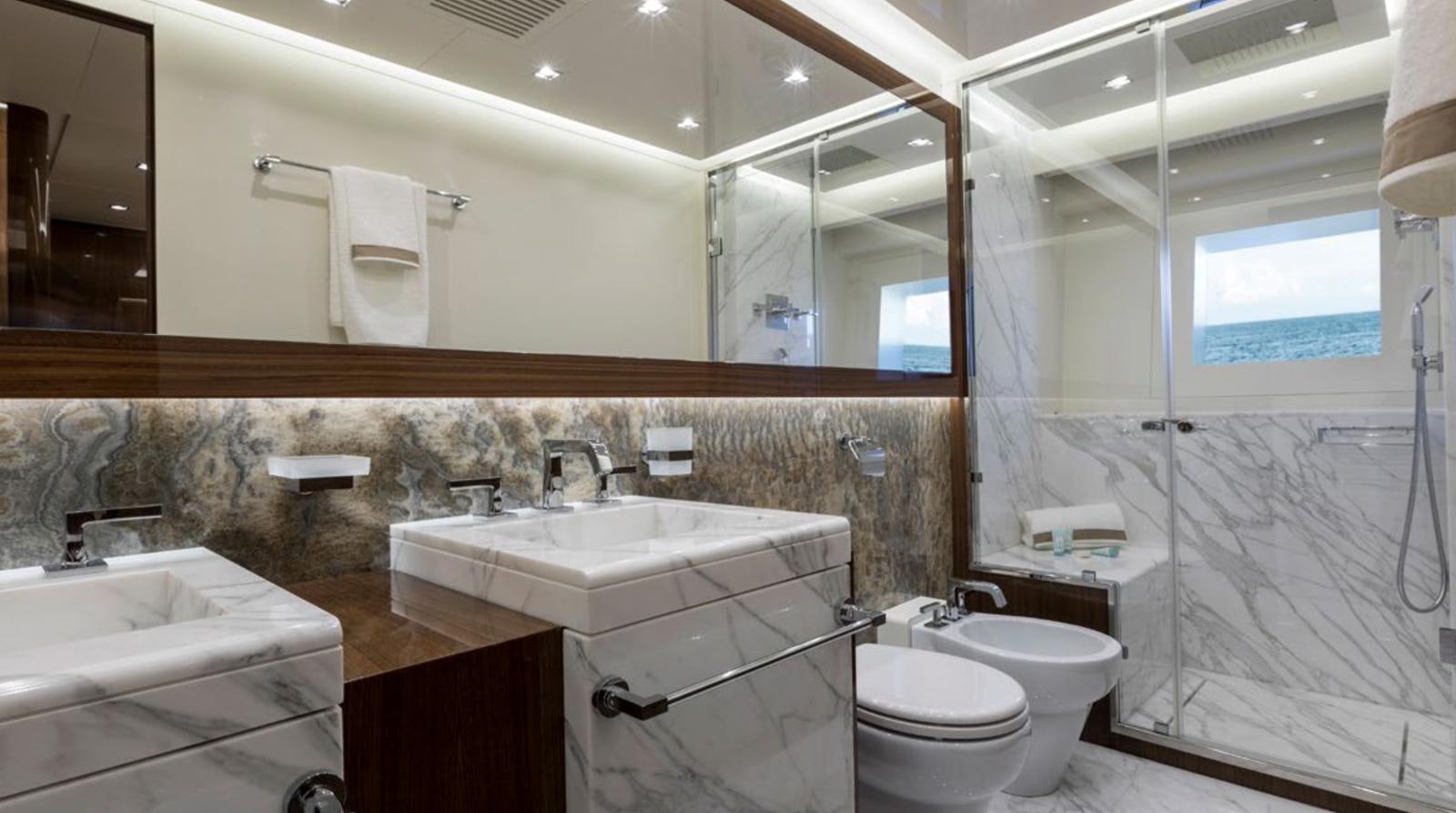 a bathroom with a large mirror aboard GOLDENEYE Yacht for Sale