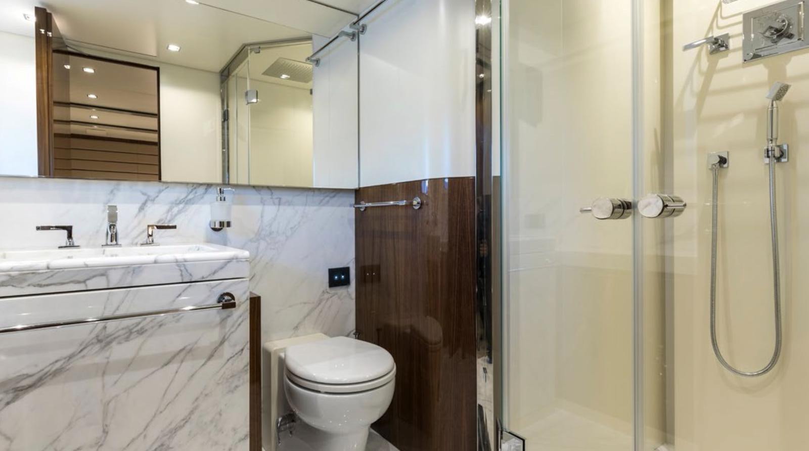 a bathroom with a toilet and a sink aboard GOLDENEYE Yacht for Sale