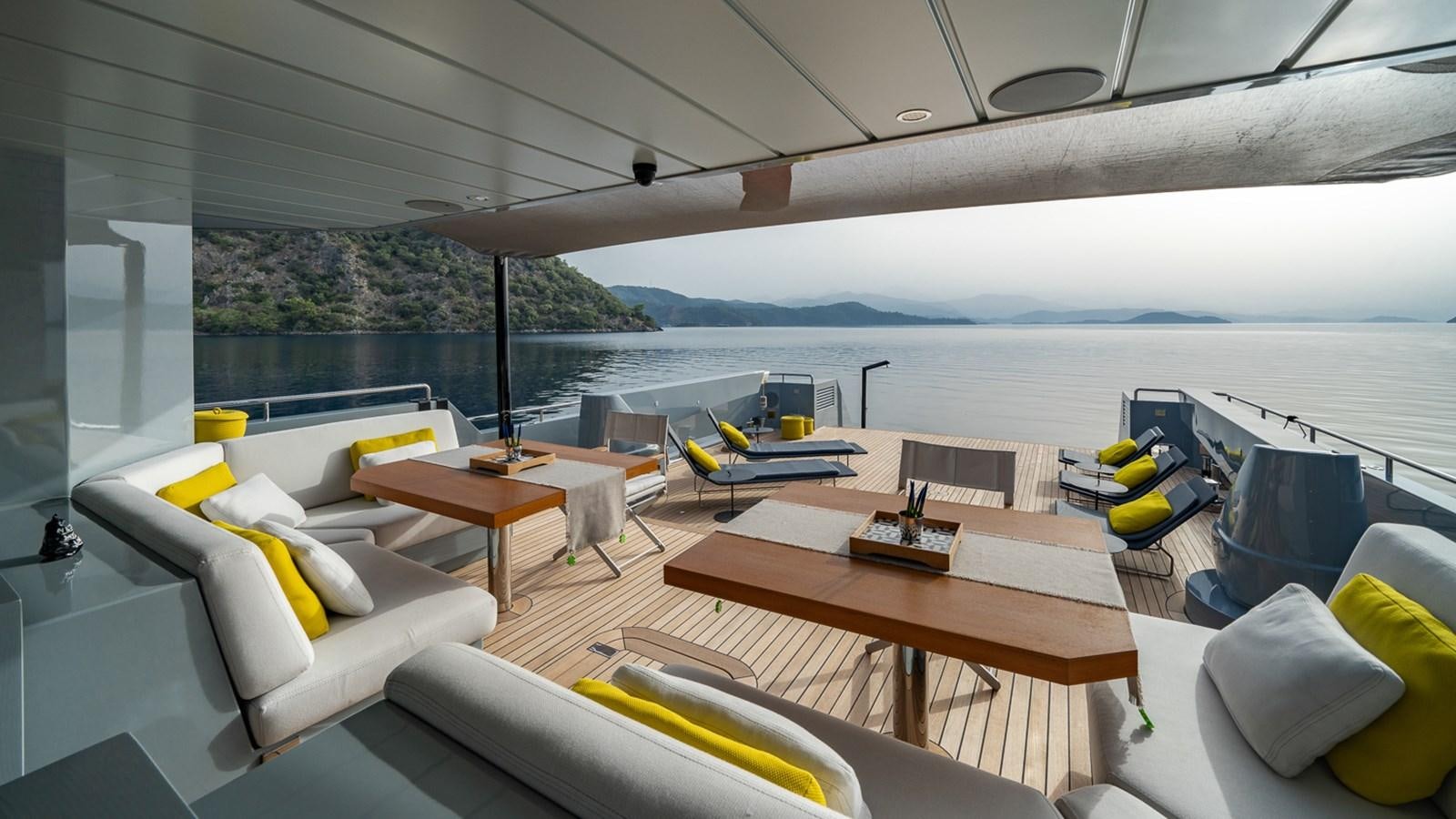 a room with a table chairs and a large window aboard ESOSH Yacht for Sale