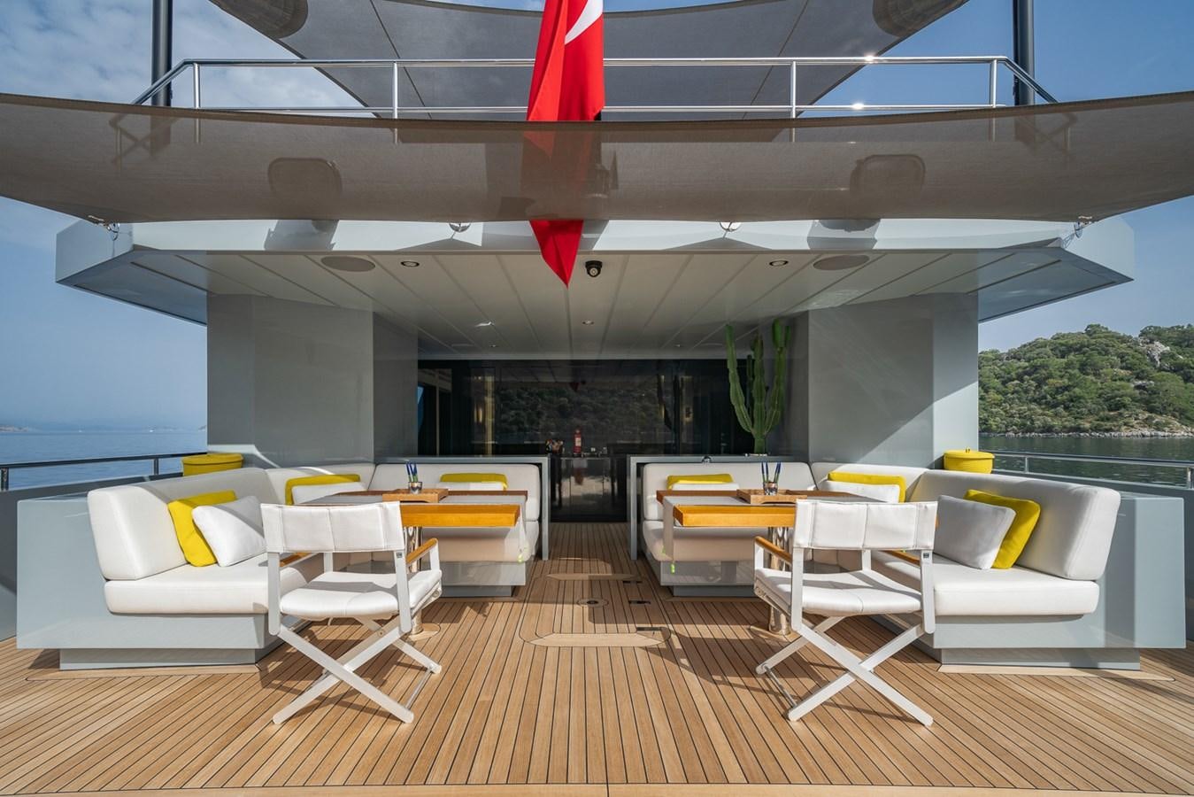 a room with tables and chairs aboard ESOSH Yacht for Sale
