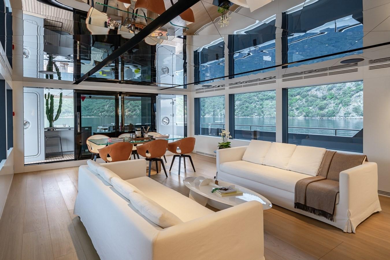 a room with couches and tables aboard ESOSH Yacht for Sale