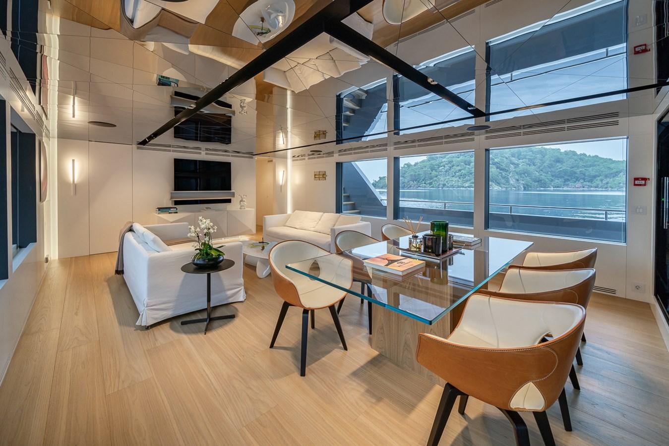 a room with a table and chairs aboard ESOSH Yacht for Sale