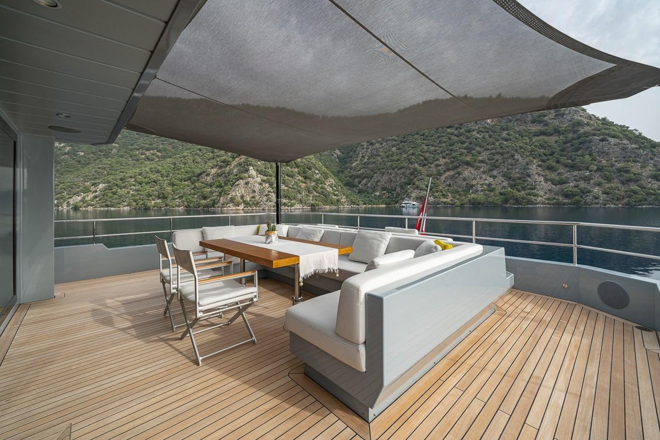 a room with a table and chairs aboard ESOSH Yacht for Sale