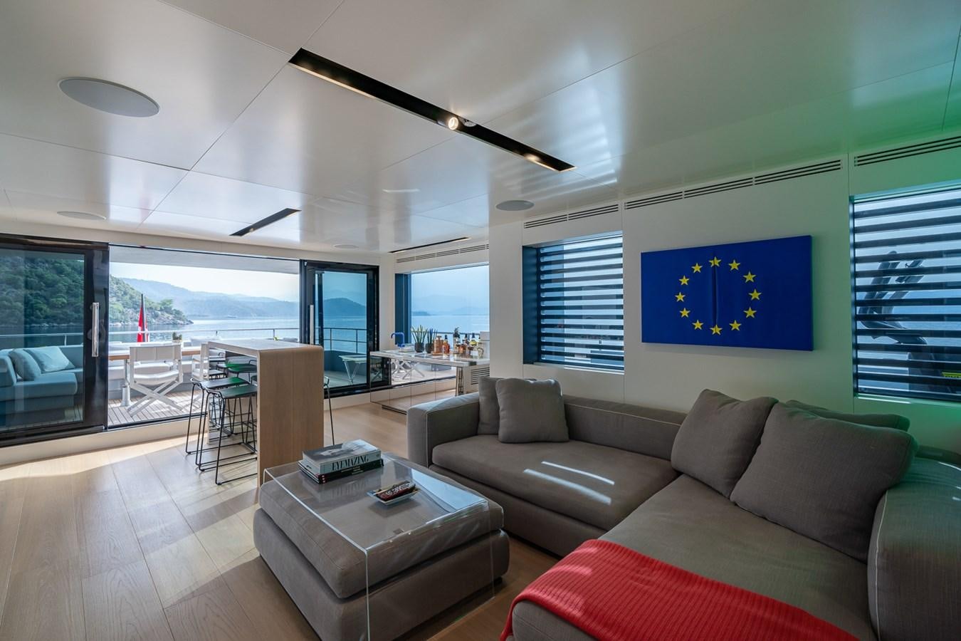 a living room with a large window aboard ESOSH Yacht for Sale