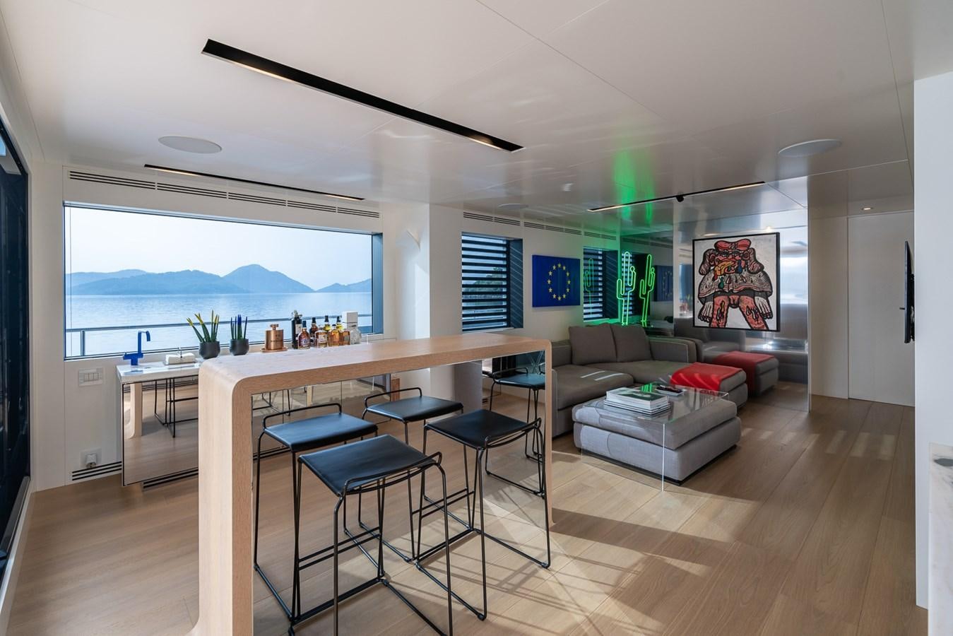 a living room with a table and couches aboard ESOSH Yacht for Sale