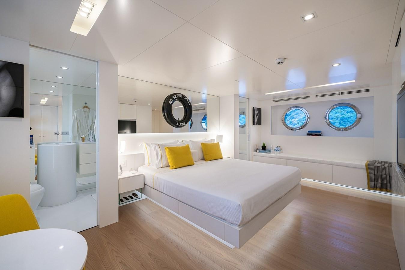 a room with a bed and a table aboard ESOSH Yacht for Sale