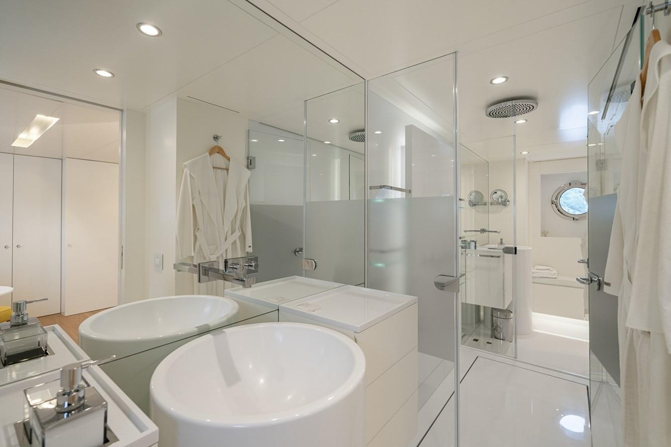 a bathroom with a large glass shower aboard ESOSH Yacht for Sale