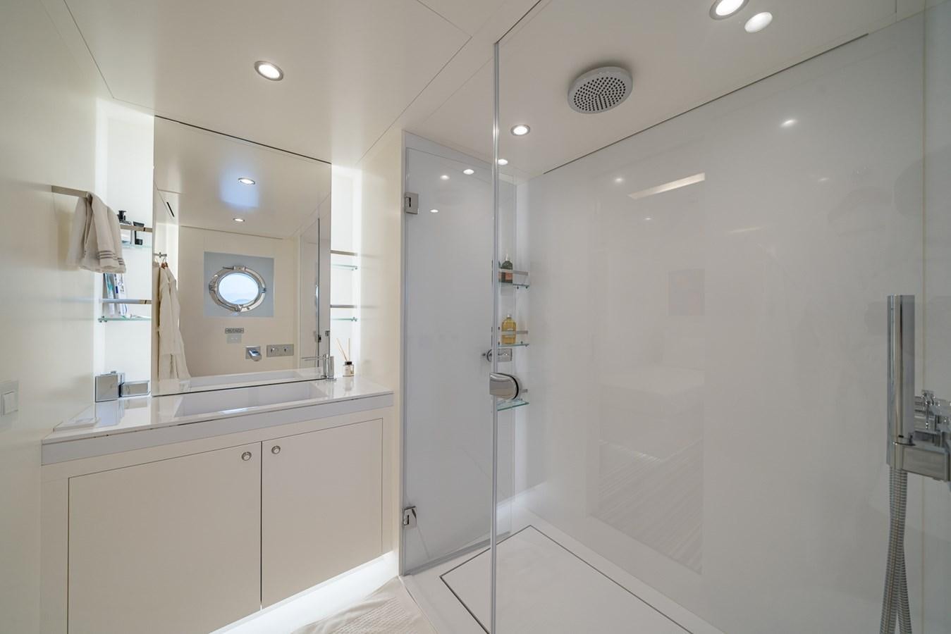 a bathroom with a shower unit and sink aboard ESOSH Yacht for Sale
