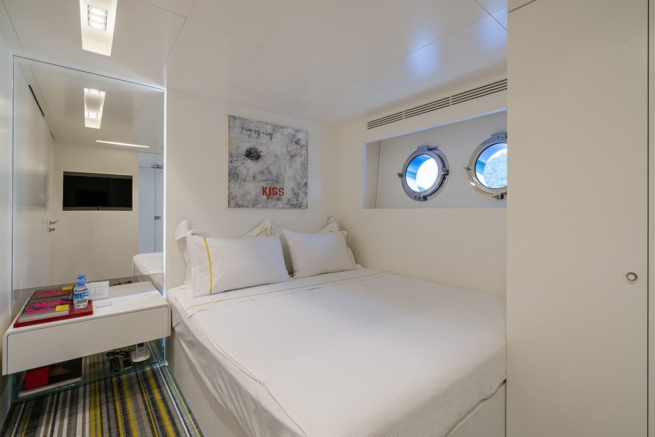a room with a bed and a table aboard ESOSH Yacht for Sale