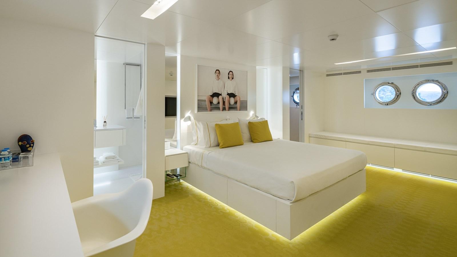 a room with a bed and a mirror aboard ESOSH Yacht for Sale