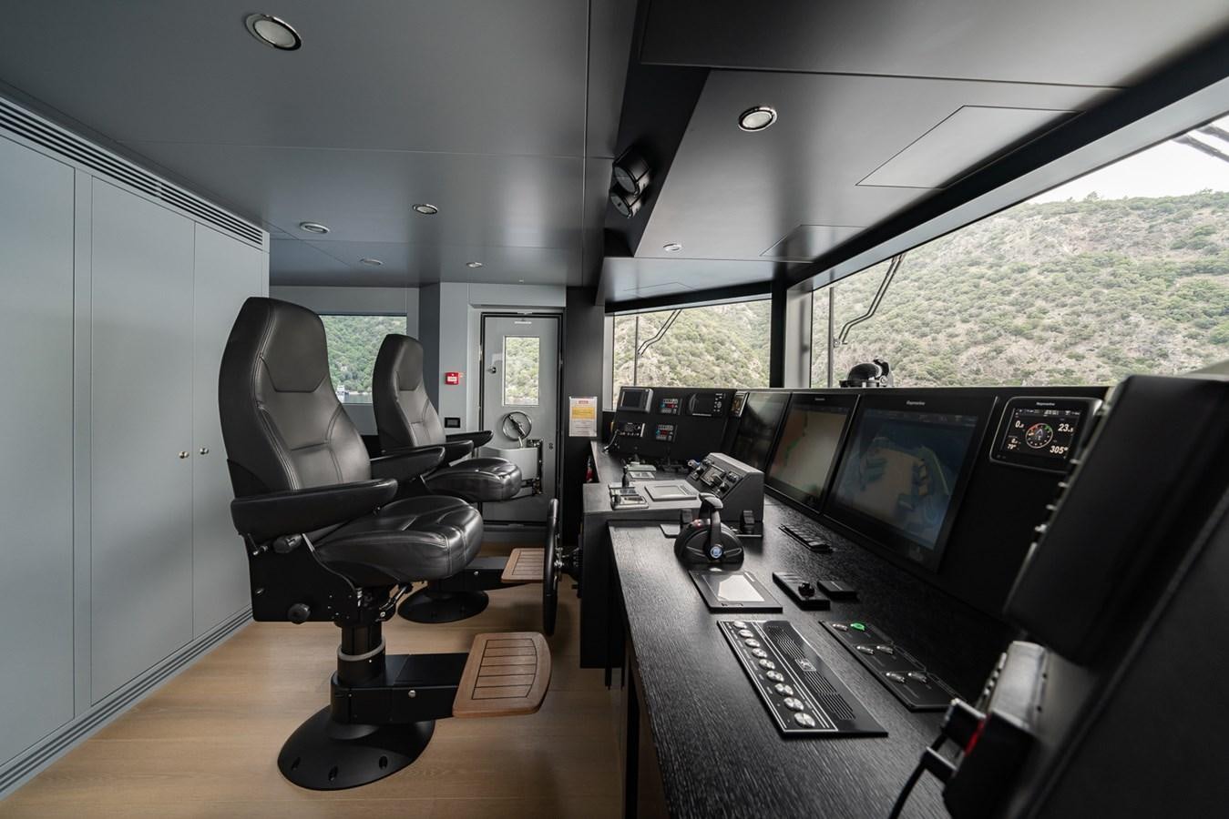 a room with a desk and computer aboard ESOSH Yacht for Sale