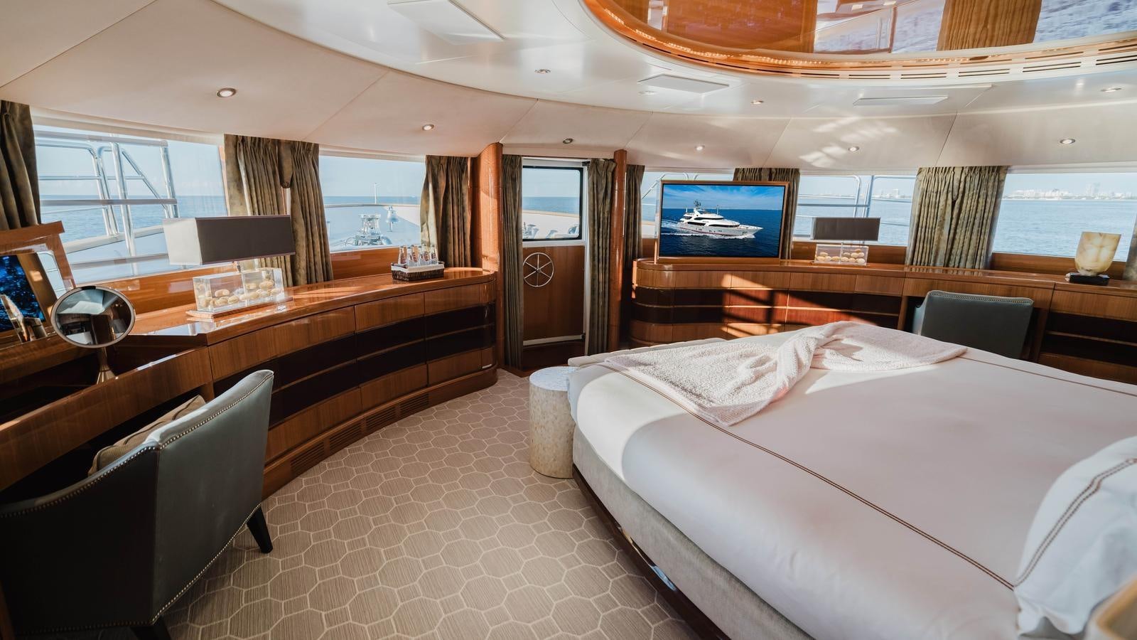a room with a bed and desk aboard GROOVER Yacht for Sale
