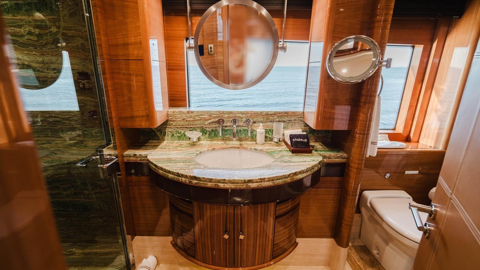 a bathroom with a large round mirror aboard GROOVER Yacht for Sale