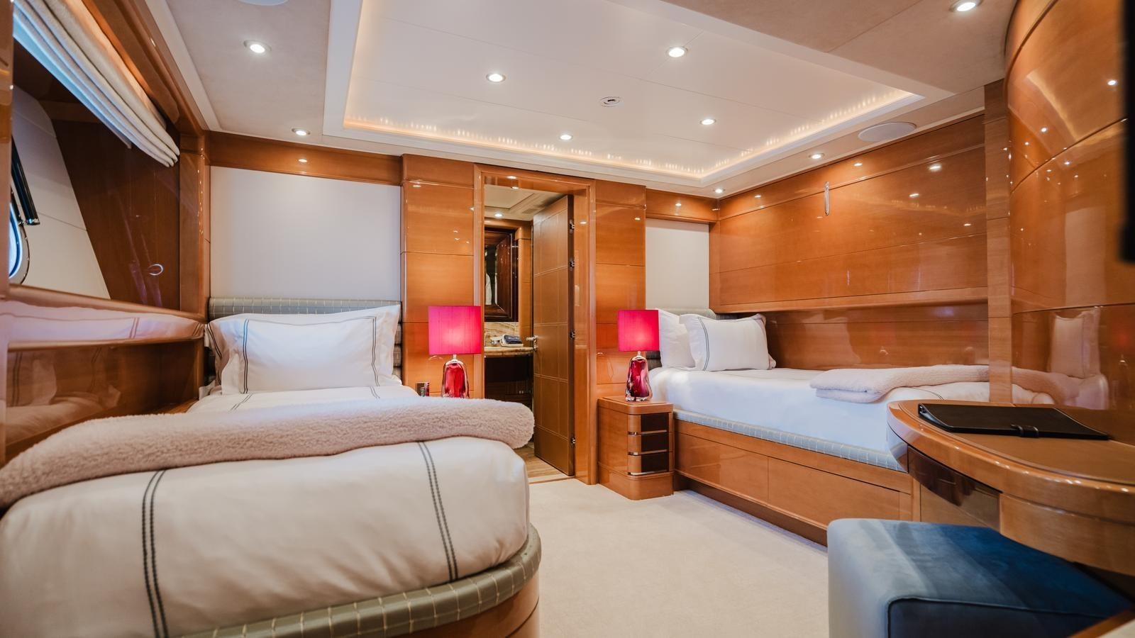 a room with a bed and a desk aboard GROOVER Yacht for Sale