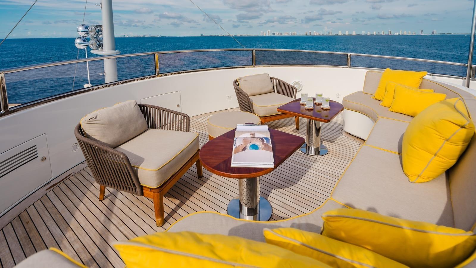 a room with a table chairs and a couch aboard GROOVER Yacht for Sale