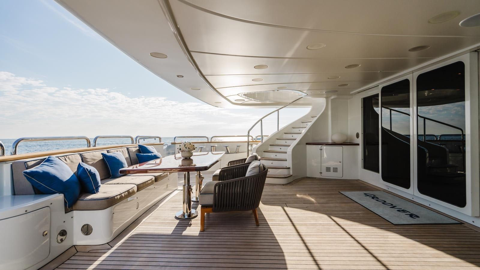 a large white boat with a large bed and a table aboard GROOVER Yacht for Sale