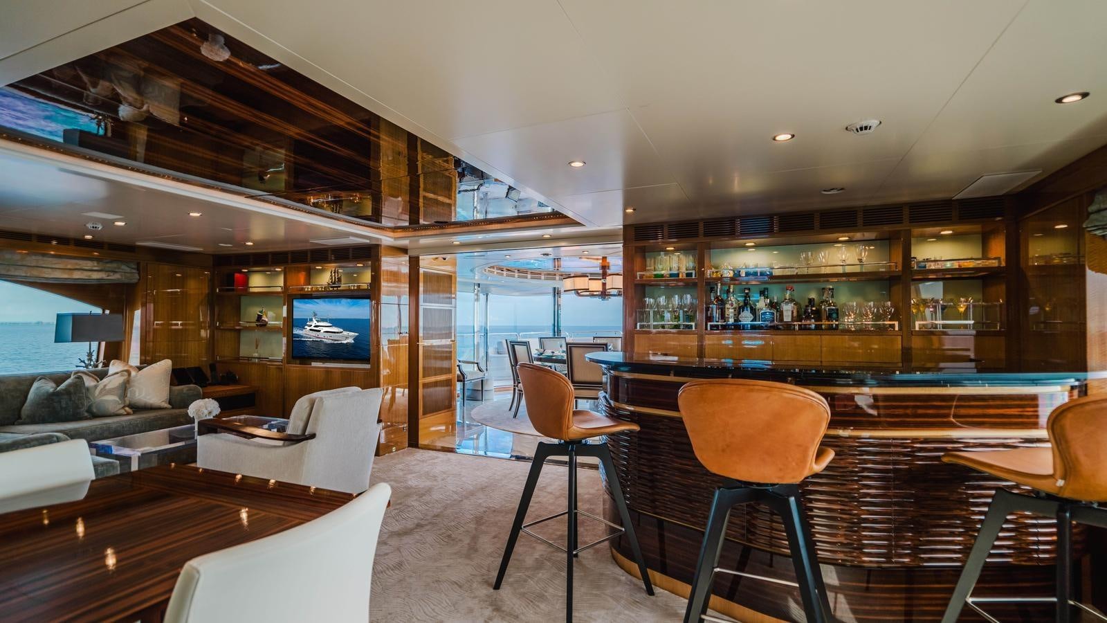 a living room with a table and chairs aboard GROOVER Yacht for Sale