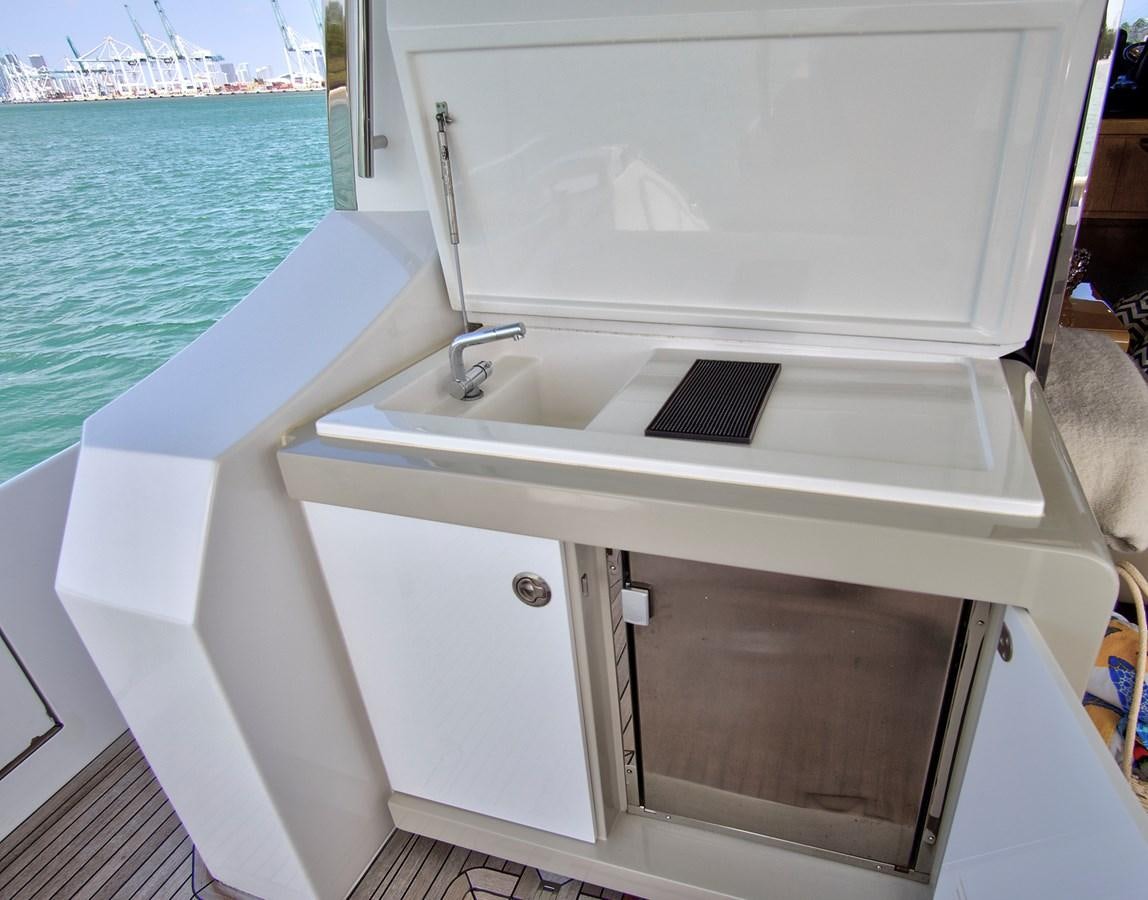 a white boat with a black screen aboard GRATITUDE Yacht for Sale