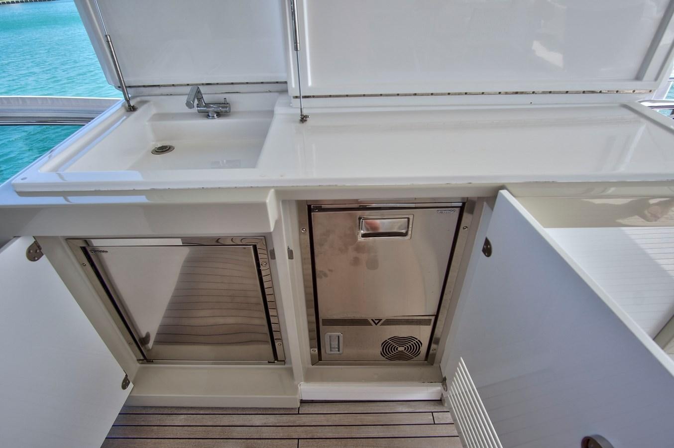 a white kitchen with a sink aboard GRATITUDE Yacht for Sale
