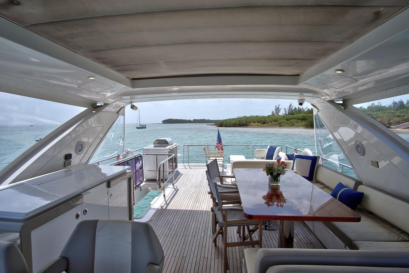 a boat with a table and chairs on it aboard GRATITUDE Yacht for Sale