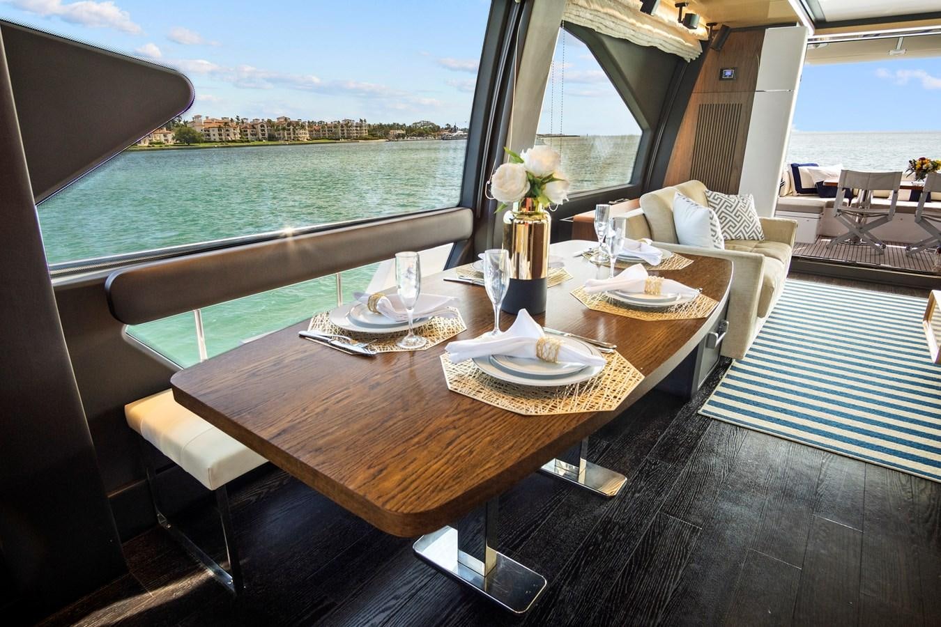 a table with plates and glasses on it aboard GRATITUDE Yacht for Sale