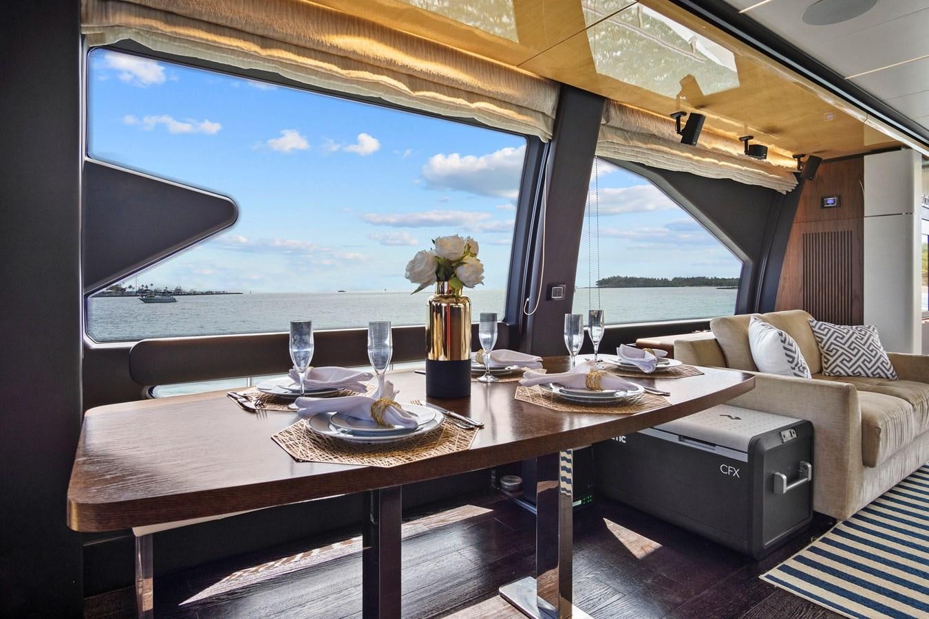 a table with plates and glasses on it aboard GRATITUDE Yacht for Sale