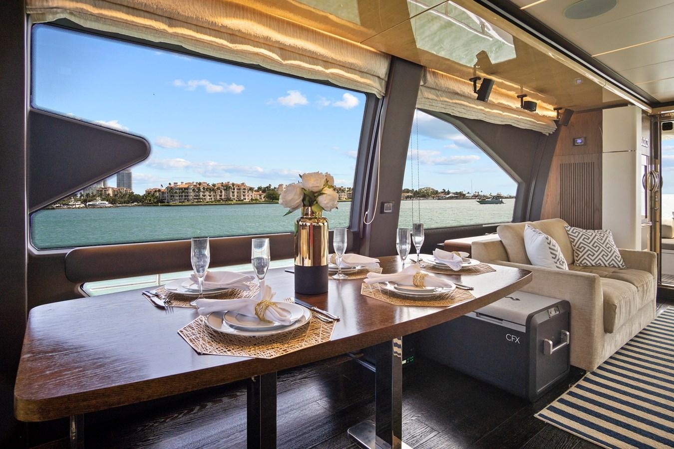 a table with plates and glasses on it aboard GRATITUDE Yacht for Sale