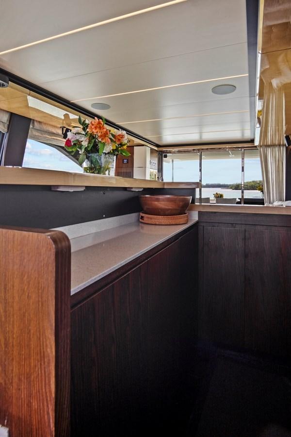 a kitchen with a vase of flowers aboard GRATITUDE Yacht for Sale