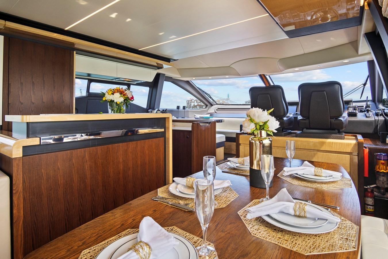 a table with plates and glasses aboard GRATITUDE Yacht for Sale
