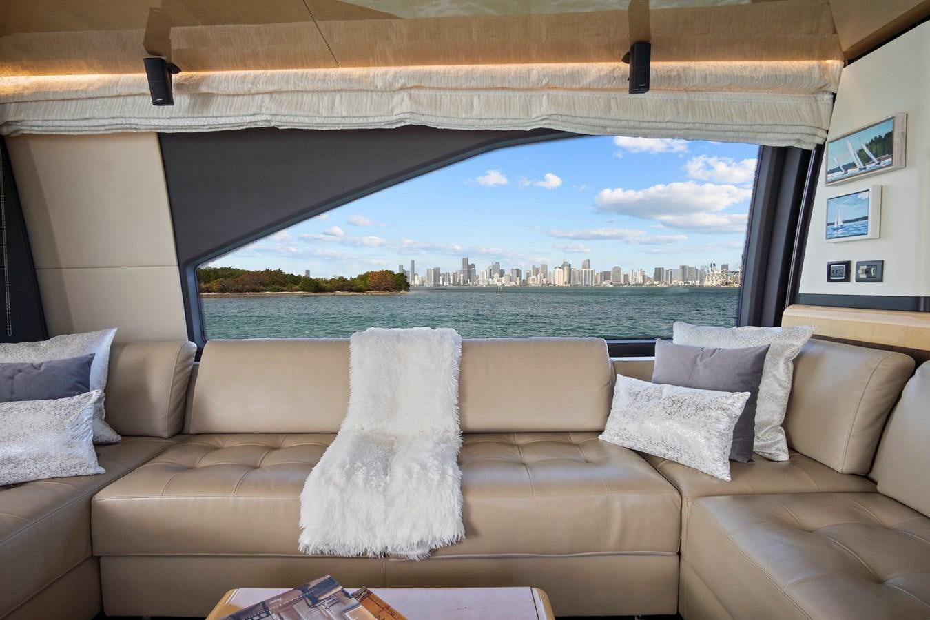 a couch with pillows and a view of a city aboard GRATITUDE Yacht for Sale