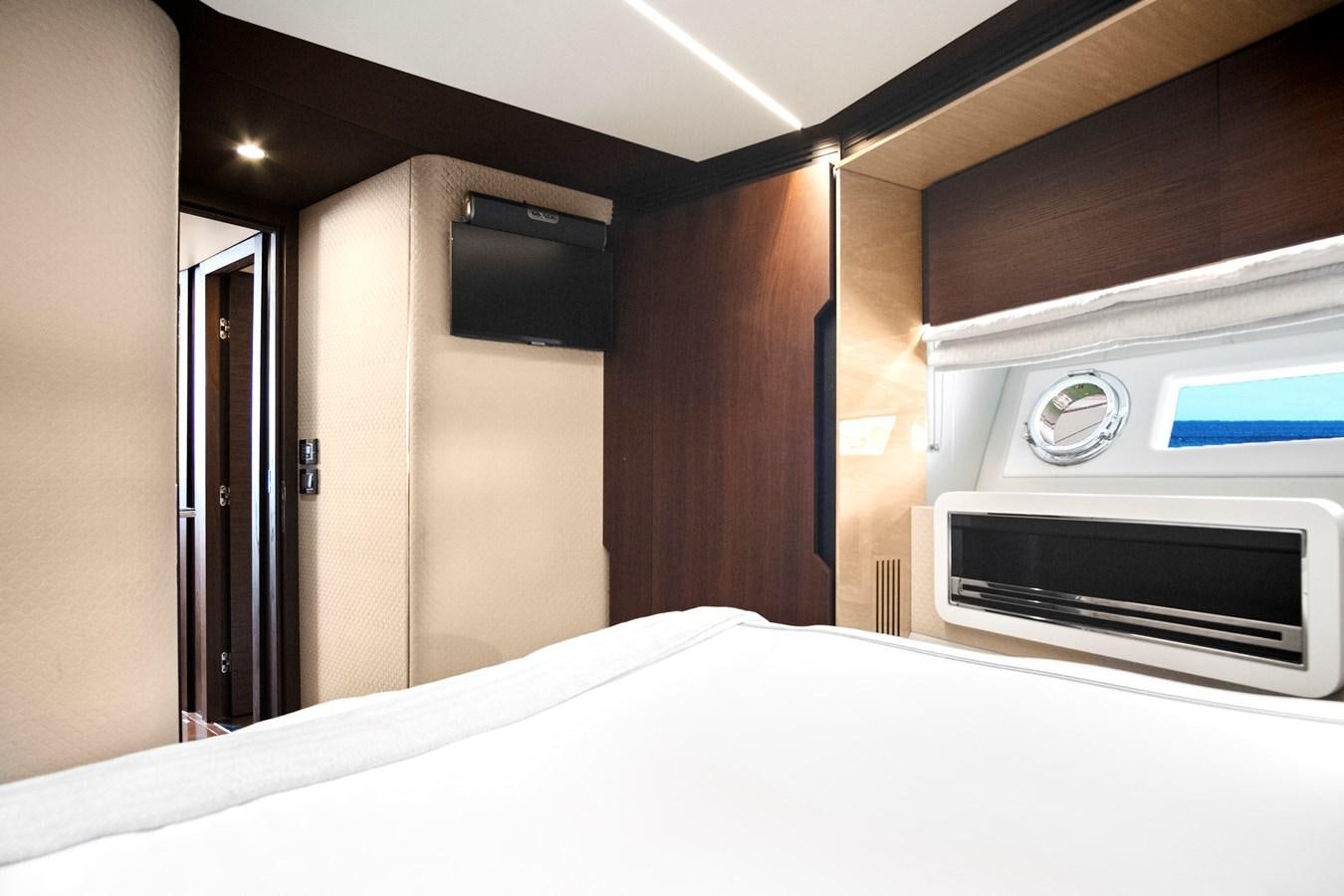 a room with a bed and a microwave aboard GRATITUDE Yacht for Sale