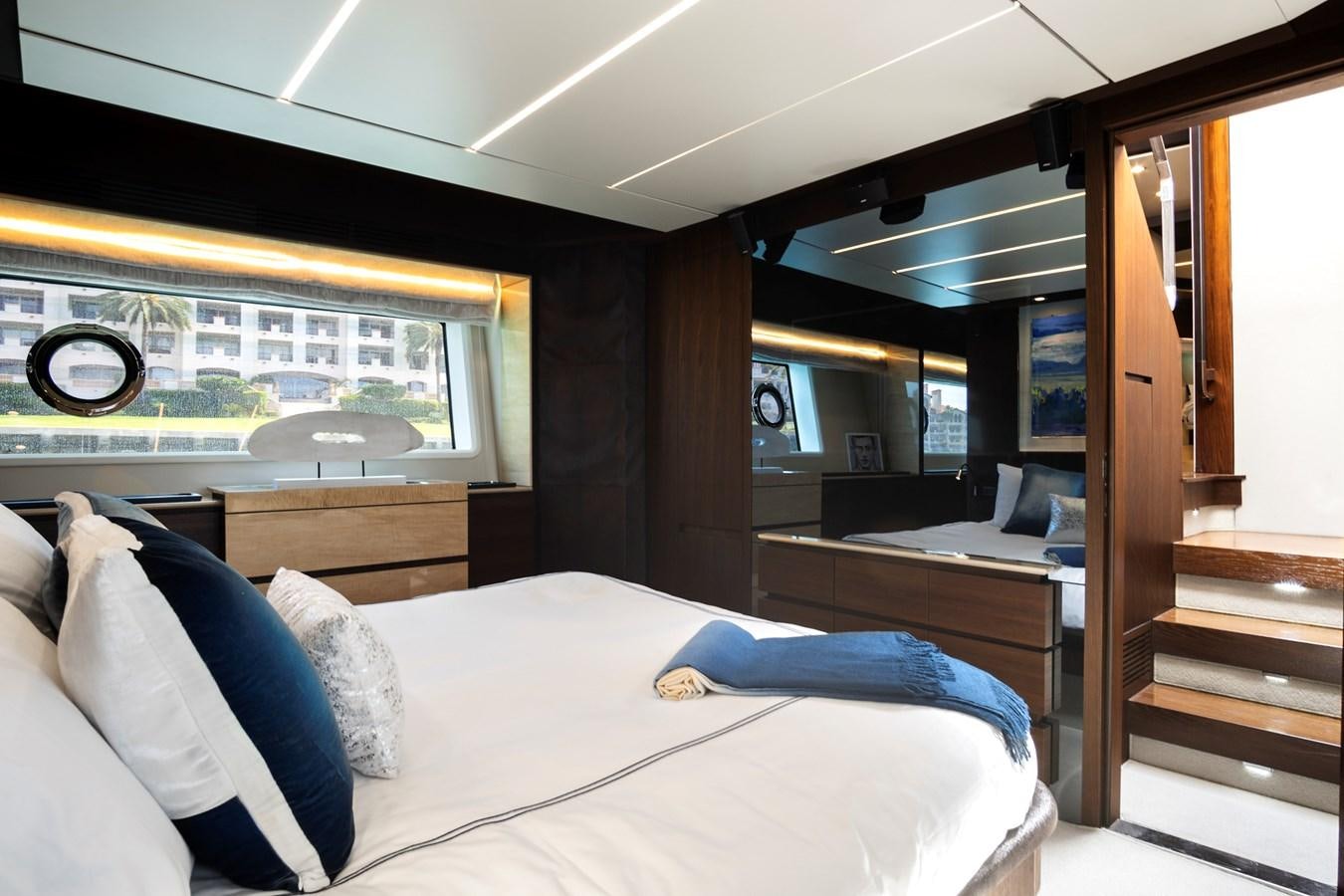 a room with a bed and a wood door aboard GRATITUDE Yacht for Sale