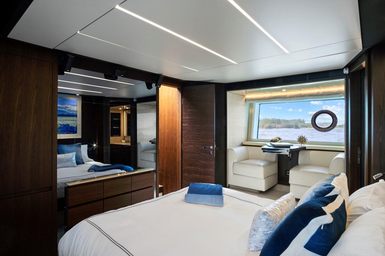 a room with a bed and a desk aboard GRATITUDE Yacht for Sale