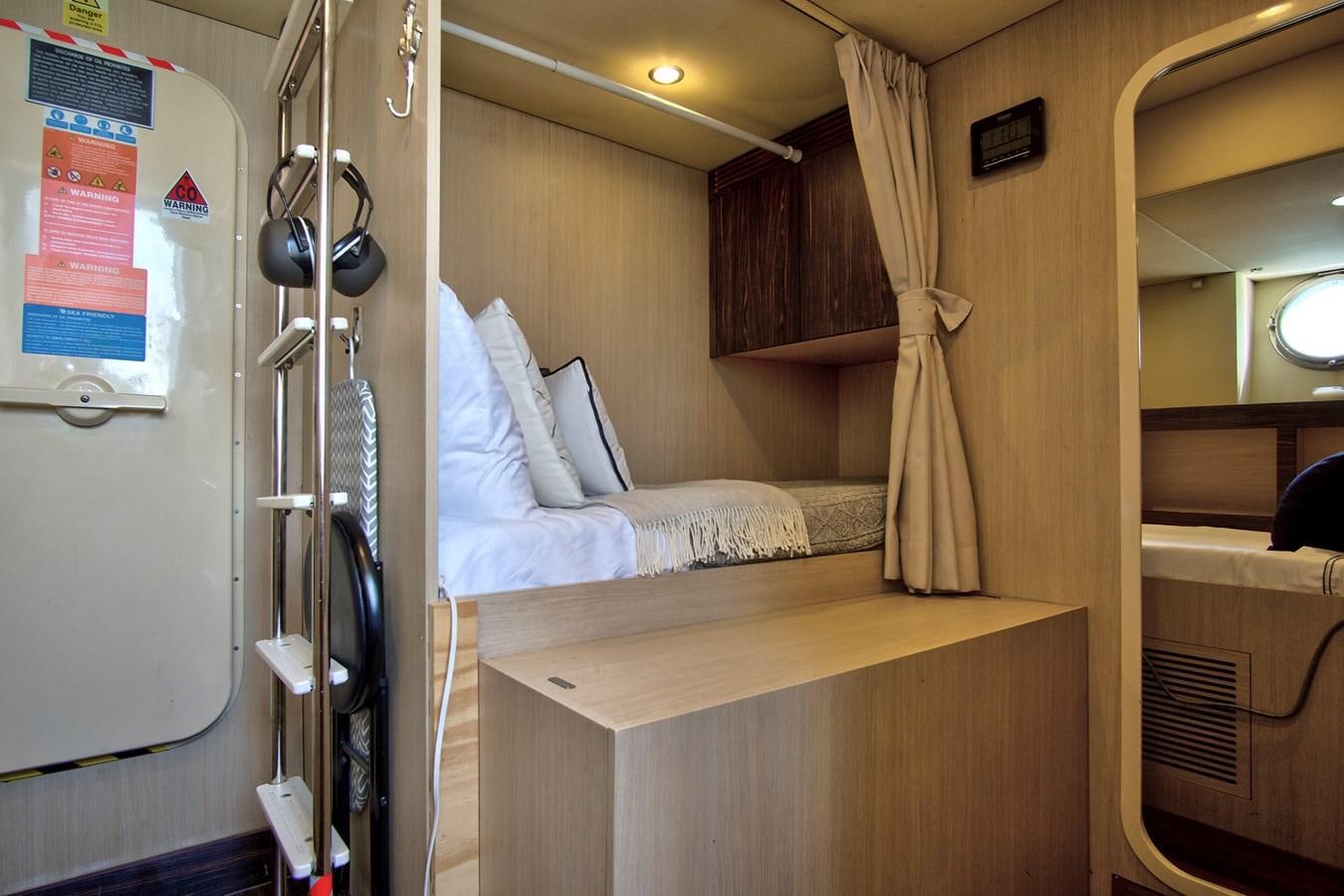 a room with a bed and a desk aboard GRATITUDE Yacht for Sale