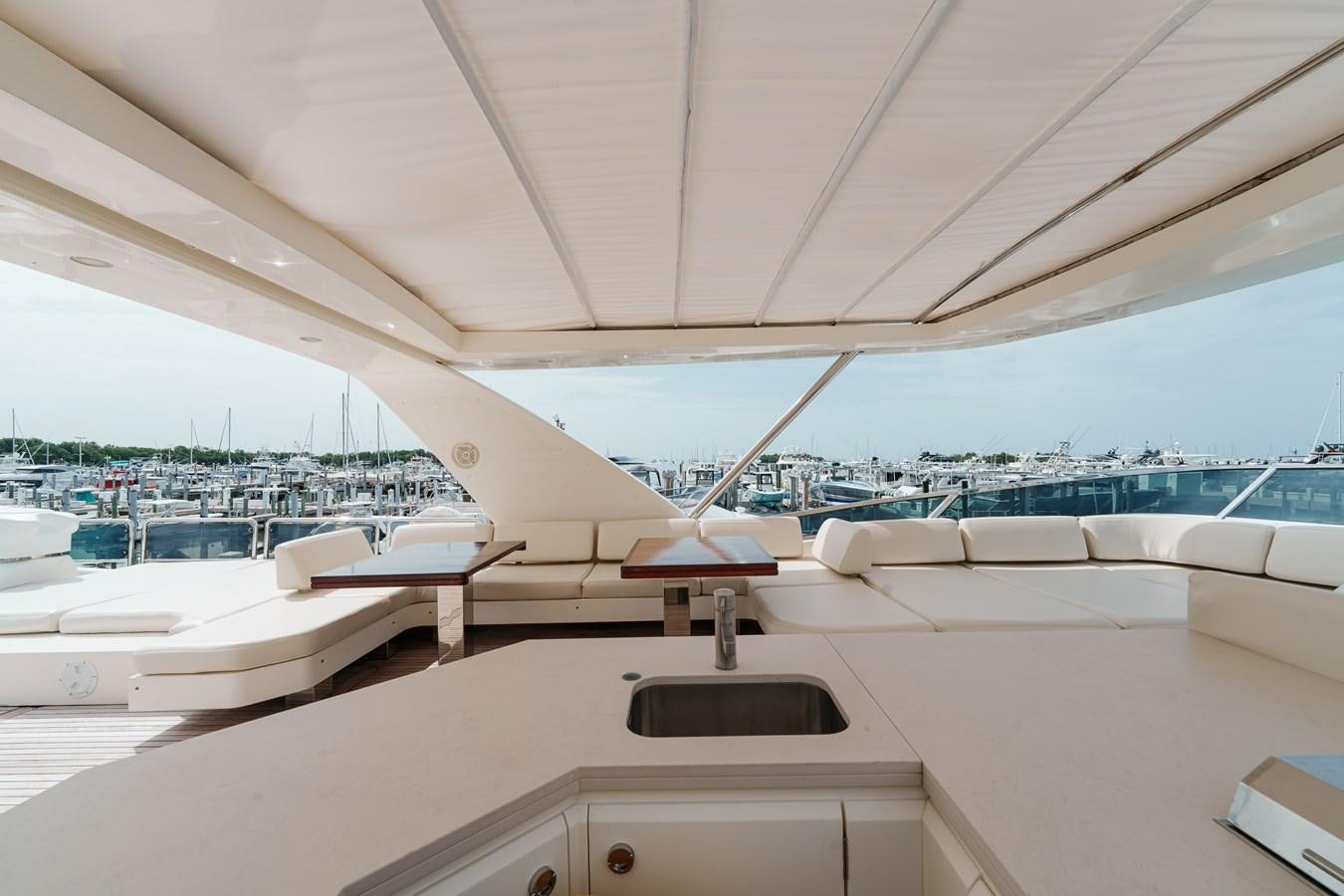 a large white lounge chair on a deck overlooking a large body of water aboard AZIMUT 85 FLY Yacht for Sale
