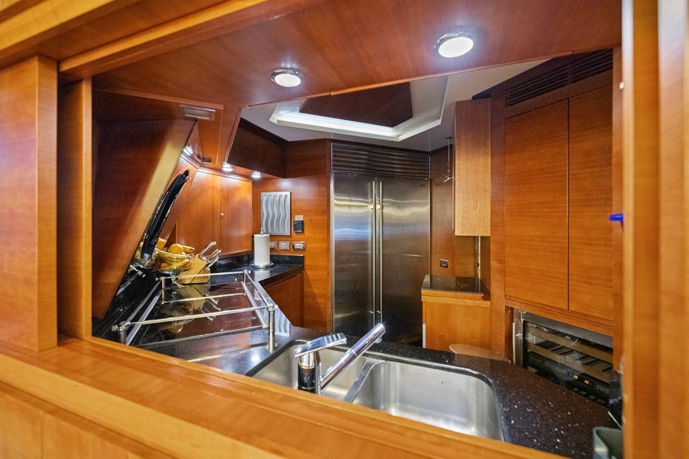 a kitchen with wooden cabinets aboard AZIMUT 85 FLY Yacht for Sale