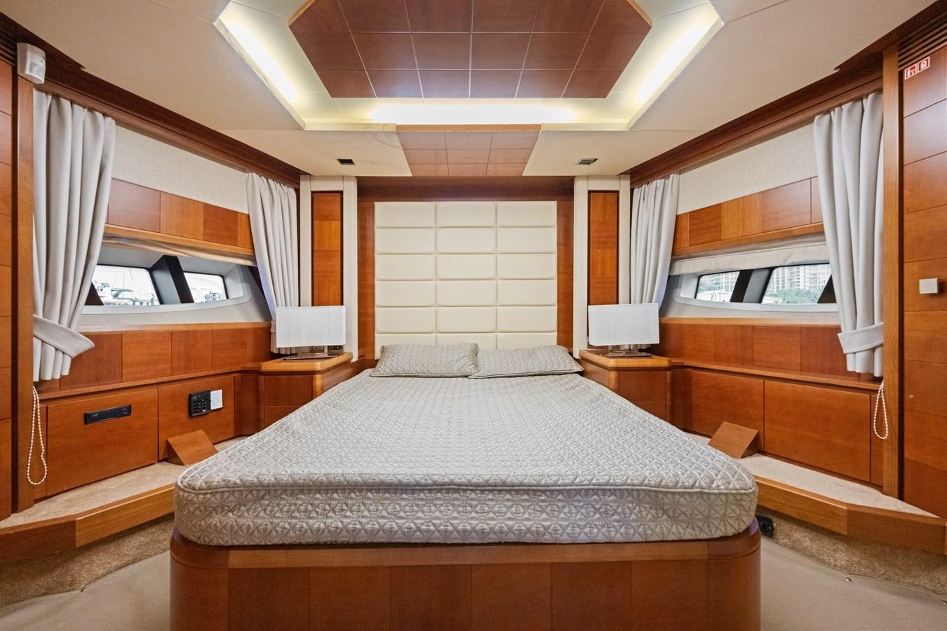 a bedroom with a bed and a desk aboard AZIMUT 85 FLY Yacht for Sale