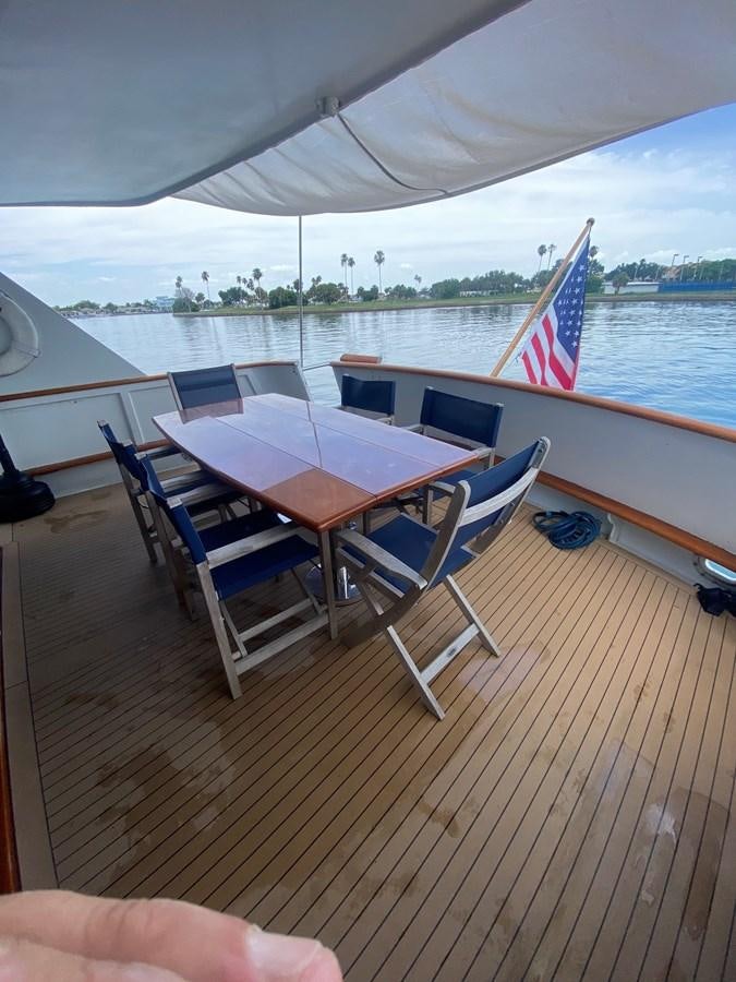 a table and chairs on a deck aboard VICTORY Yacht for Sale