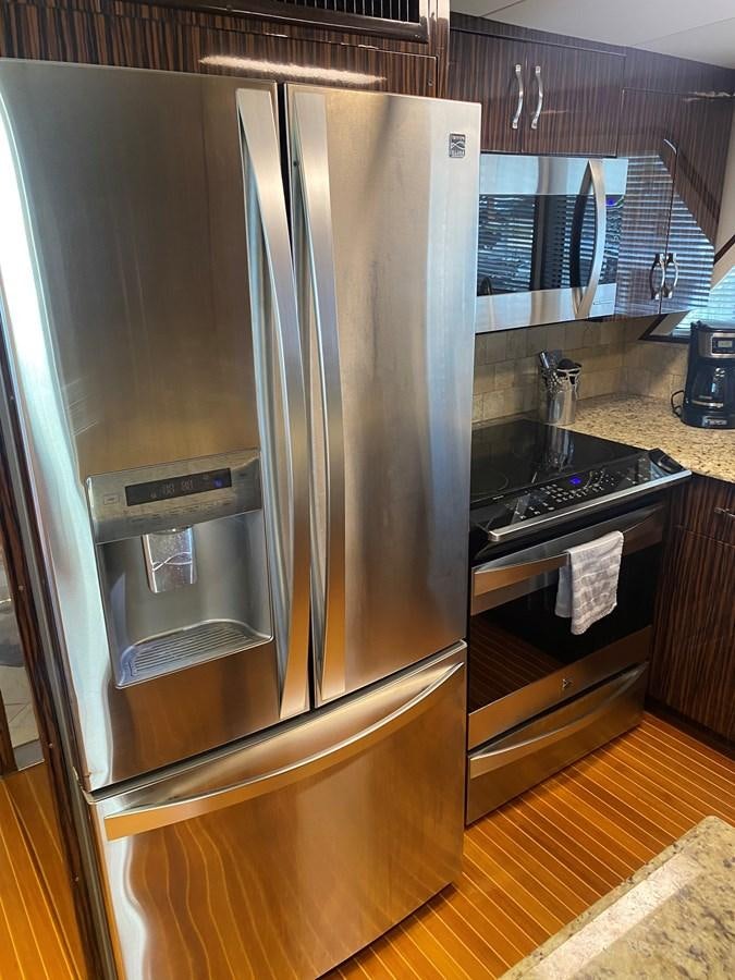 a stainless steel refrigerator in a kitchen aboard VICTORY Yacht for Sale