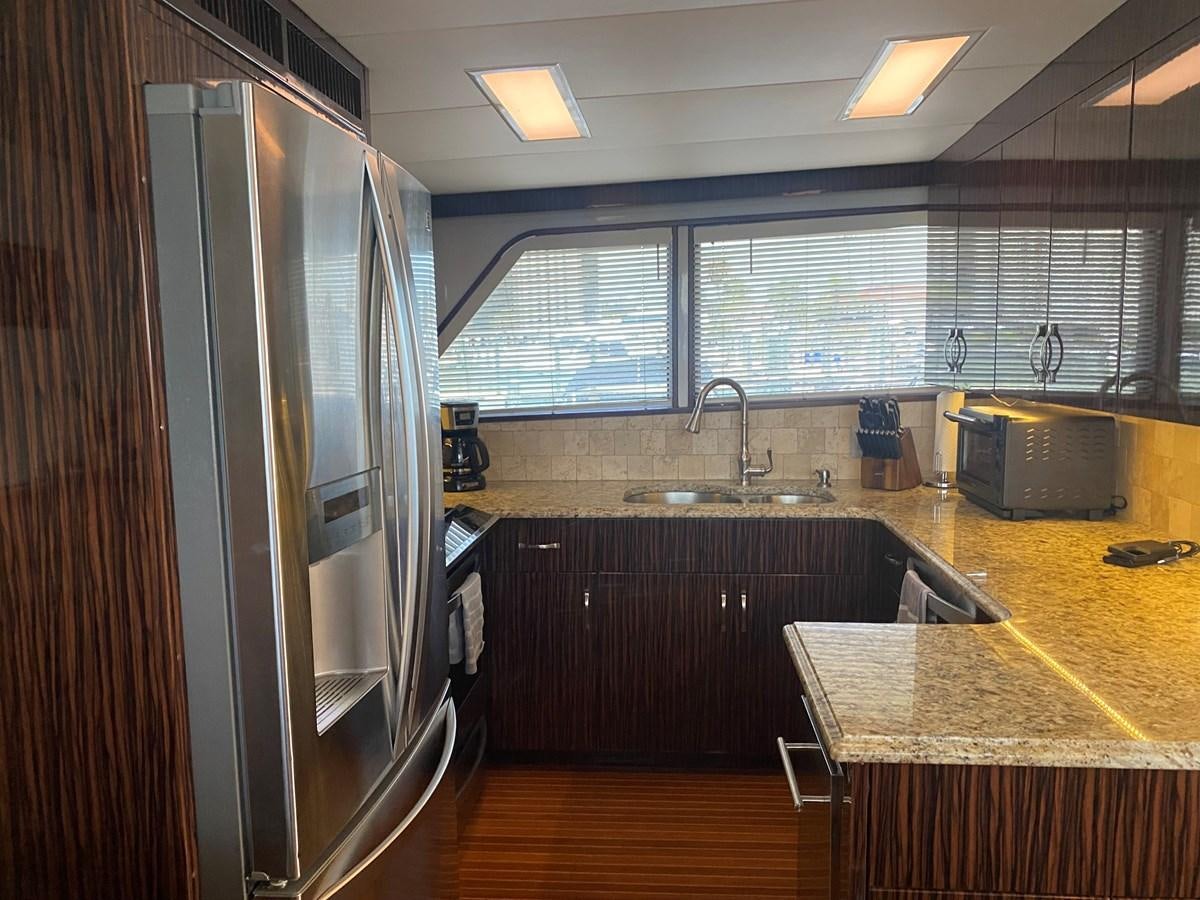 a kitchen with a stainless steel refrigerator aboard VICTORY Yacht for Sale