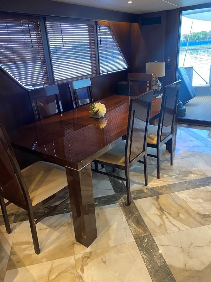a wood table in a room aboard VICTORY Yacht for Sale