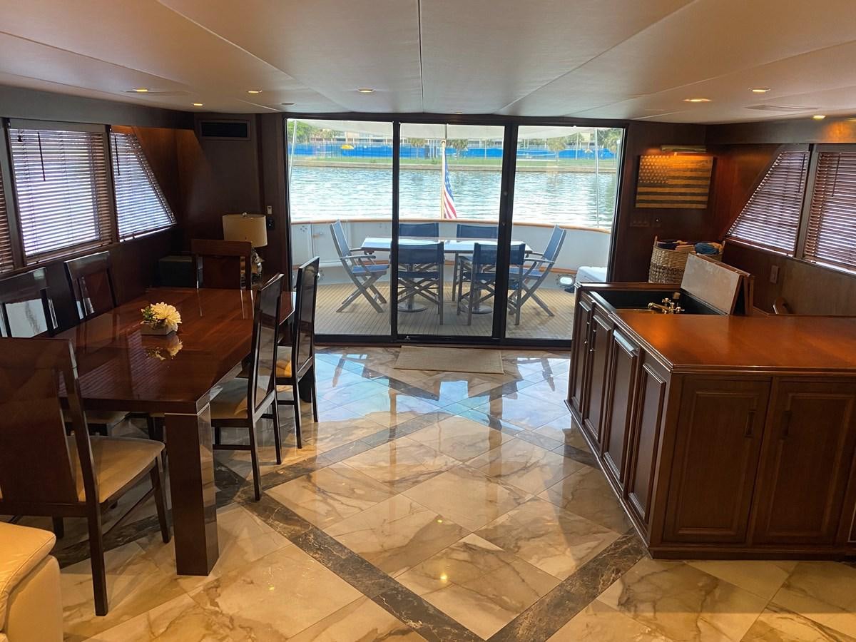 a room with a table chairs and a window aboard VICTORY Yacht for Sale