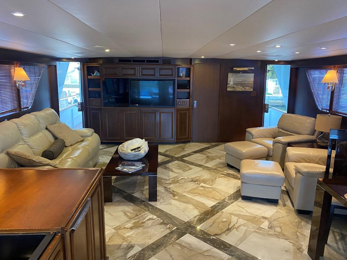 a living room with a table and chairs aboard VICTORY Yacht for Sale