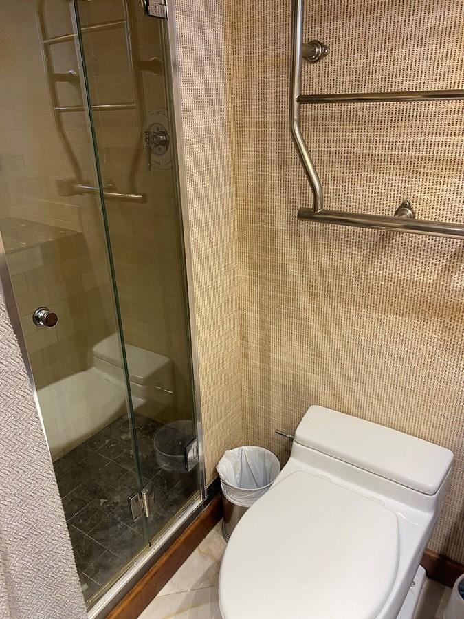 a bathroom with a glass shower aboard VICTORY Yacht for Sale