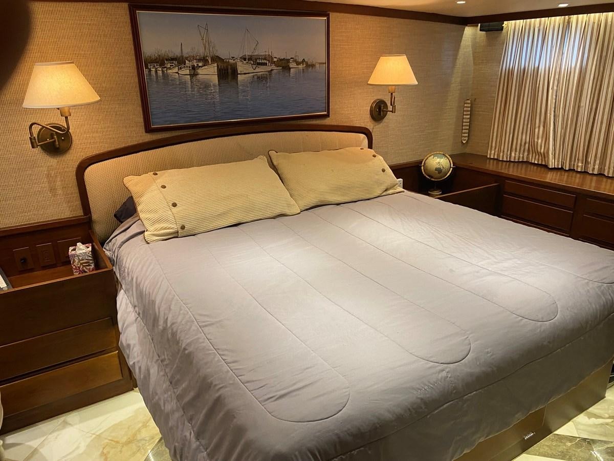 a bed with a white sheet aboard VICTORY Yacht for Sale