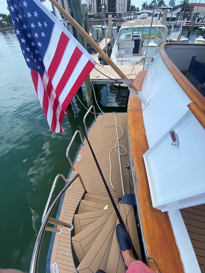 a boat with a flag on the front aboard VICTORY Yacht for Sale