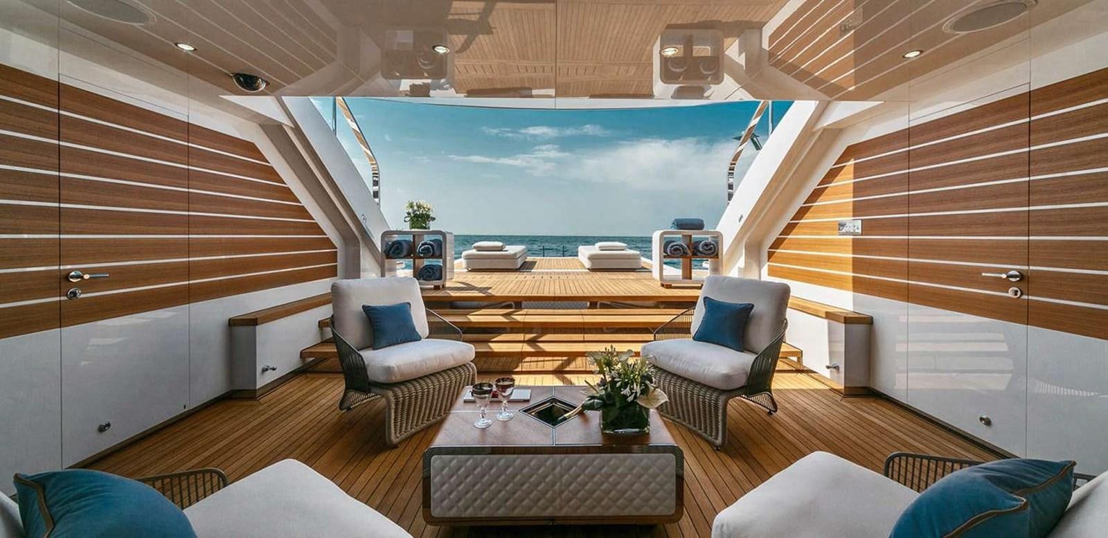 a room with a couch and a table and chairs aboard EL LEON Yacht for Sale