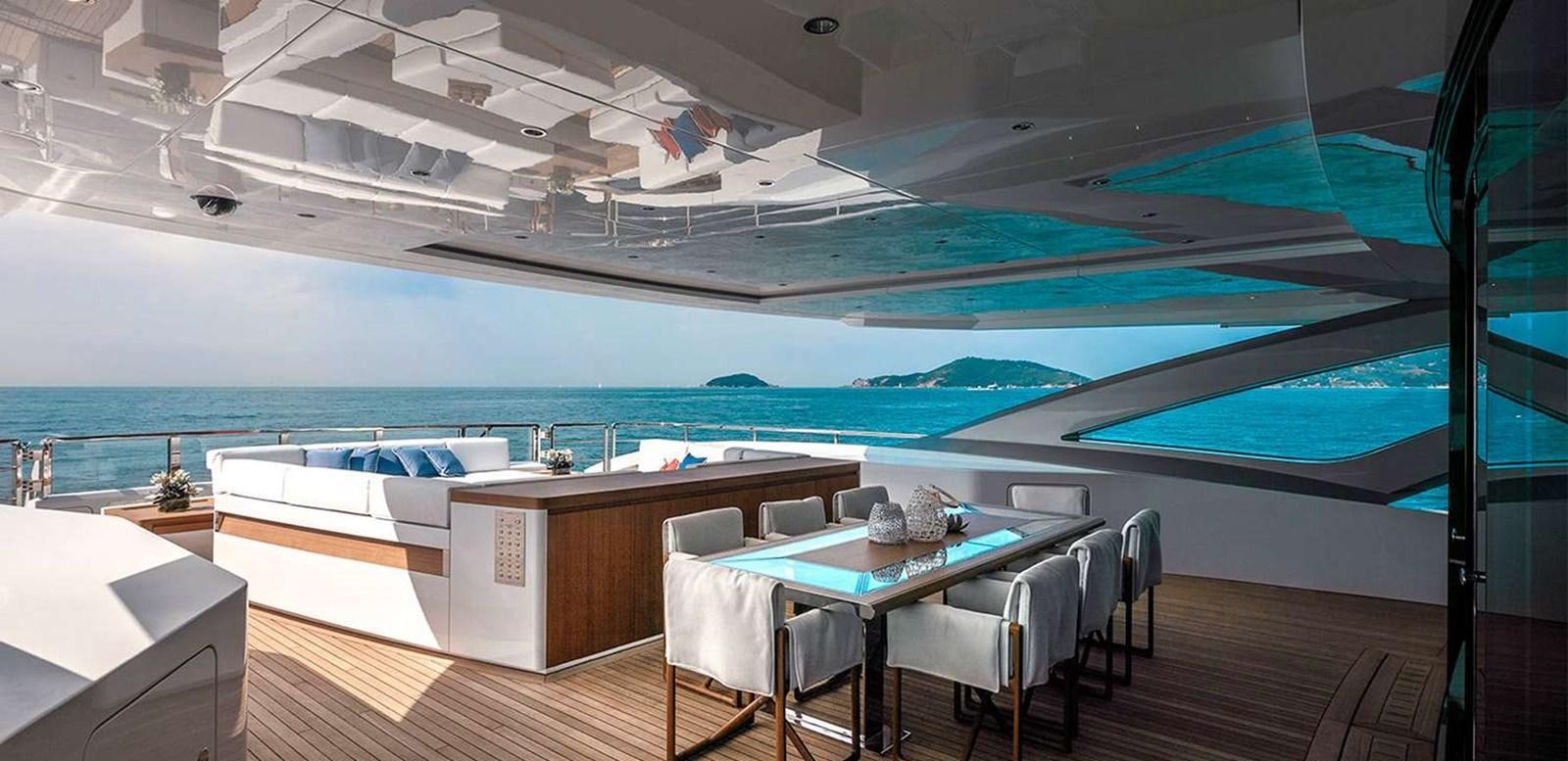 a room with a table and chairs aboard EL LEON Yacht for Sale