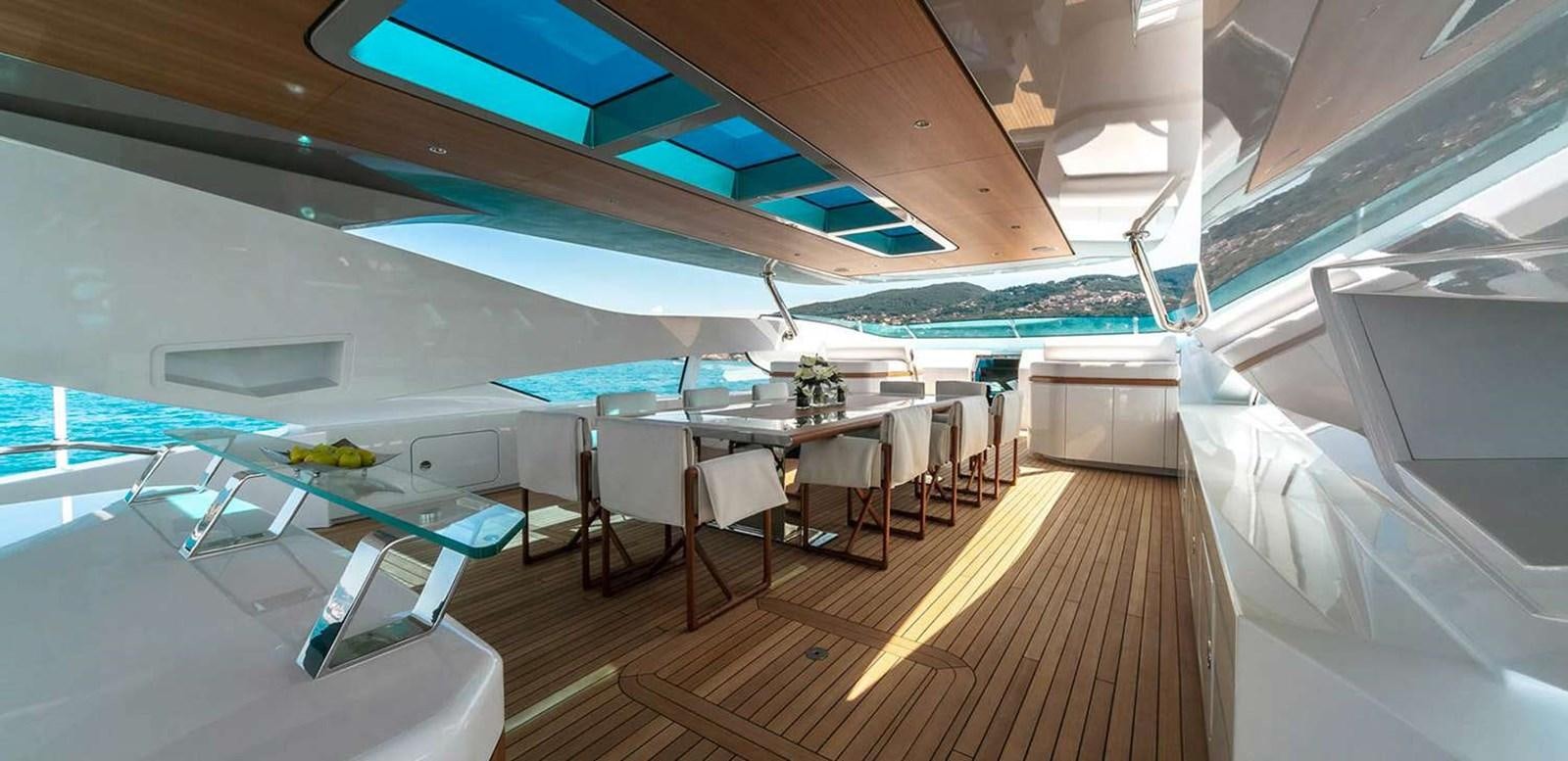 a room with a table and chairs aboard EL LEON Yacht for Sale